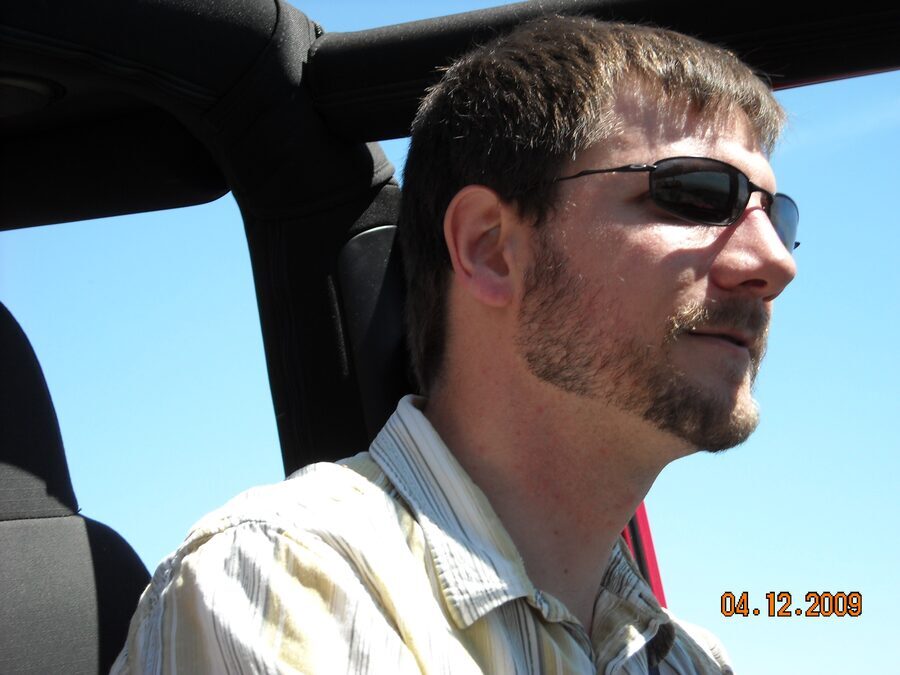 At the wheel.